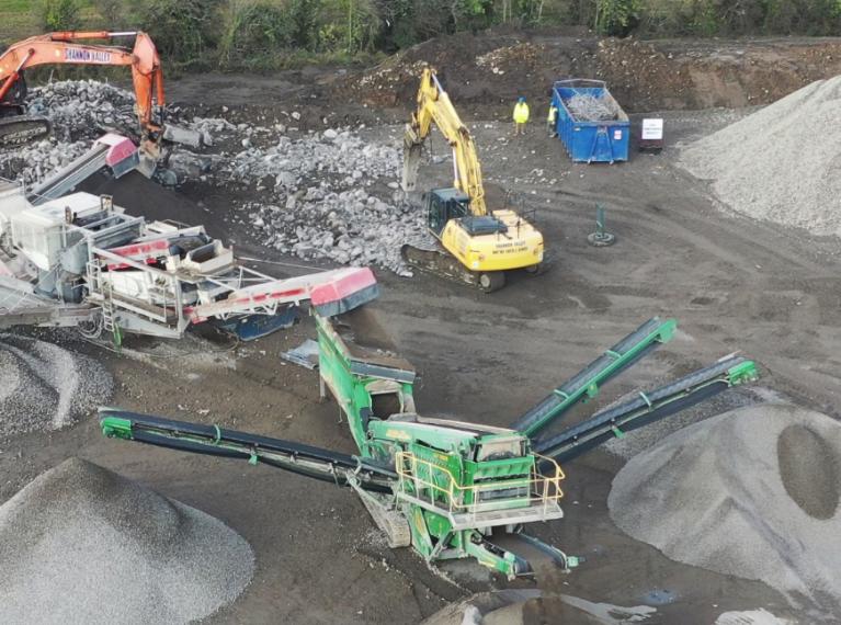 aerial shot of multiple machines working in a gravel pit